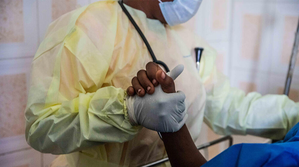 A midwife examining a woman in the delivery room